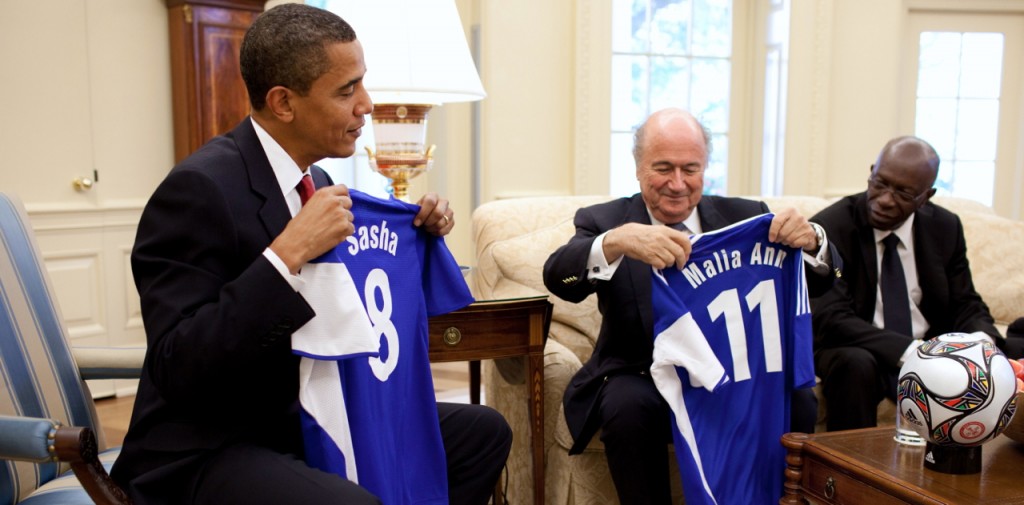President Barack Obama is presented with soccer jerseys for his daughters, Sasha and Malia, by FIFA President Joseph Blatter during a meeting in the Oval Office of the White House on Monday, July 27, 2009.  (Official White House Photo by Pete Souza)